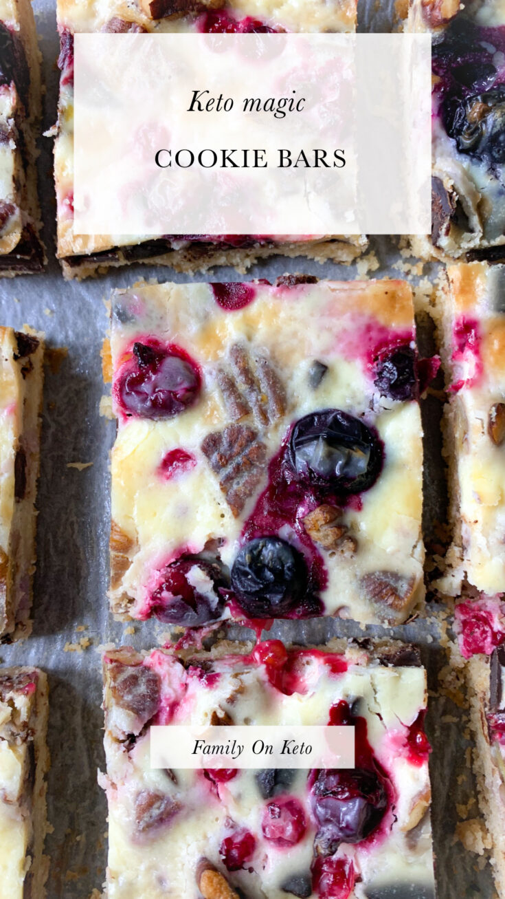 Photo of keto magic cookie bars with berries, pecans and dark chocolate and condensed keto milk cream